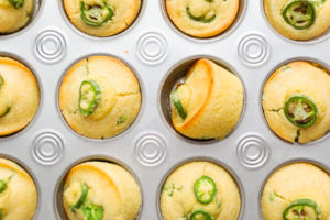 Cornbread muffins - Arina Photography Flat lay. Freshly baked cornbread muffins with spicy jalapeno pepper in muffin pan.