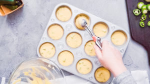 Cornbread muffins - Arina Photography Step by step. Flat lay. Filling metal muffin pan with cornbread batter to bake spicy jalapeno cornbread muffins.
