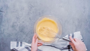 Baking cornbread - Arina Photography Step by step. Flat lay. Mixing ingredients together in glass mixing bowl for spicy jalapeno cornbread muffins.