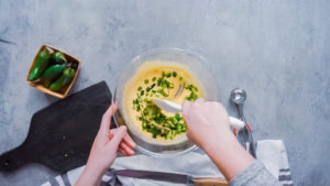 Baking cornbread - Arina Photography Step by step. Flat lay. Mixing ingredients together in glass mixing bowl for spicy jalapeno cornbread muffins.