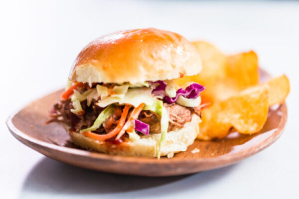 BBQ pulled pork sandwich in shape of small sliders with brioche buns.