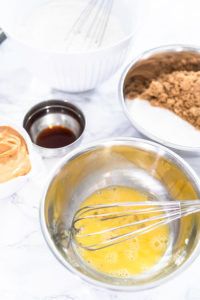 Peanut butter cookies - Arina Photography Whisked eggs and vanilla in stainless bowl before adding to dough mixture