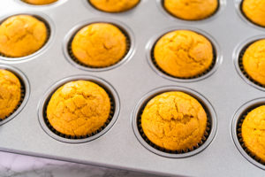 Pumpkin spice cupcake - Arina Photography Freshly baked pumpkin spice cupcake cooling in cupcake pan.
