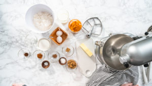 Pumpkin spice cupcake - Arina Photography Flat lay. Ingredients to bake pumpkin spice cupcake on a marble countertop.