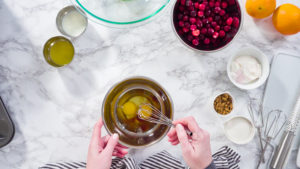 Flat lay. Step by step. Mixing ingredients in a mixing bowl to bake cranberry muffins.