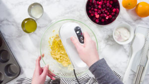 Flat lay. Step by step. Mixing ingredients in a mixing bowl to bake cranberry muffins.