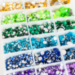 Color and size variety of rhinestones in the craft box.