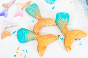 Mermaid tails made out of modeling clay and painted with acrylic paint.