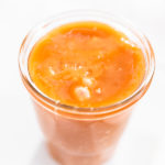 Homemade caramel in a small glass jar.