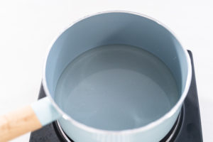 Preparing sugar syrup in a small saucepan over an electric pan.