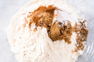 Pumpkin pancakes - Arina Photography Whisking flour in a glass mixing bowl to prepare dry ingredients for pumpkin pancakes.