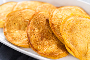 Pumpkin pancakes - Arina Photography A platter of perfectly cooked golden-brown pumpkin pancakes, fresh off the skillet.