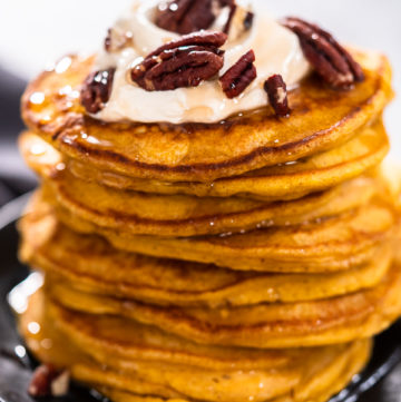 Pumpkin pancakes - Arina Photography A platter of perfectly cooked golden-brown pumpkin pancakes, fresh off the skillet.