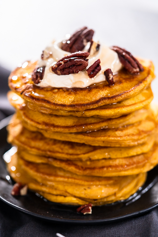 Pumpkin pancakes - Arina Photography A platter of perfectly cooked golden-brown pumpkin pancakes, fresh off the skillet.