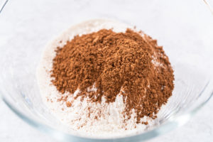 Dry ingredients with cocoa powder in a mixing bowl
