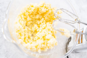 Butter and sugar mixture being creamed with hand mixer