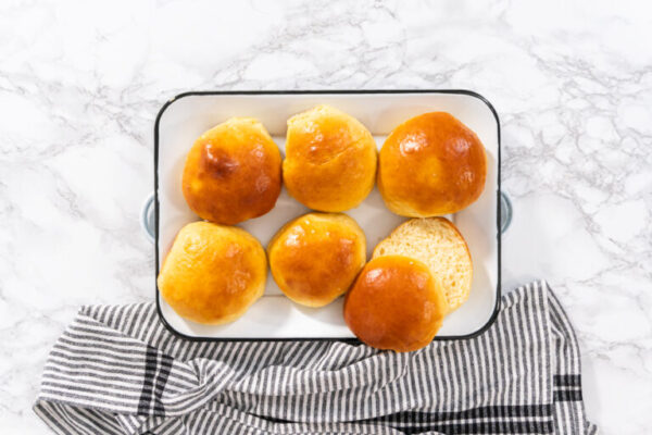 Baking brioche buns - Arina Photography Flat lay. Freshly baked brioche buns on a metal serving tray.