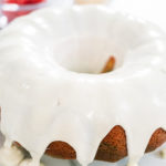 Vanilla-glazed Bundt cake with smooth, even drips cascading down the golden brown edges.
