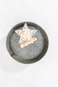 Mid-process image showing just white chocolate in a star bowl on the tra