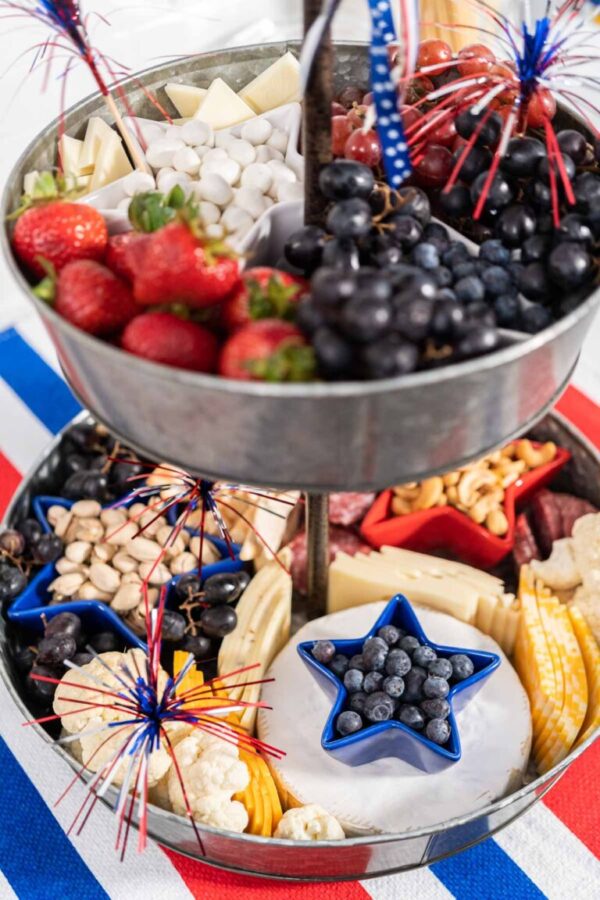 Strawberries, grapes, and yogurt raisins in a galvanized tray with blue star bowl.