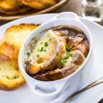 Homemade French onion soup with toasted baguette.
