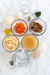 Creamy wild mushroom soup - Arina Photography Flat lay. Measured ingredients in a glass mixing bowl to prepare creamy wild mushroom soup.