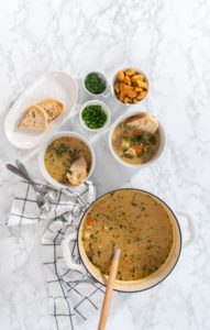 Creamy wild mushroom soup - Arina Photography Flat lay. Serving creamy wild mushroom soup made out of dehydrated wild mushrooms in white bowls with sourdough bread.