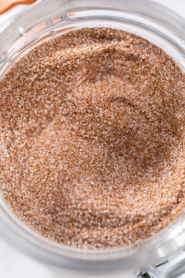 Cinnamon Sugar - Arina Photography Cinnamon sugar in a glass mason jar on the marble surface.