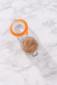 Flat lay. Preparing cinnamon sugar in a glass mason jar.