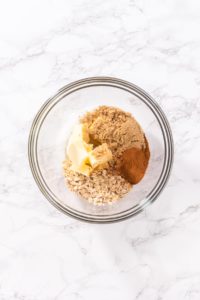 Cinnamon Dessert Pizza - Arina Photography Brown sugar, cinnamon, oats, and butter in a glass bowl before mixing for cinnamon filling.