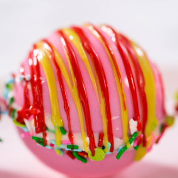 Christmas hot chocolate bombs on a white plate.