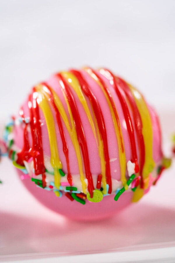 Hot chocolate bombs - Arina Photography Christmas hot chocolate bombs on a white plate.