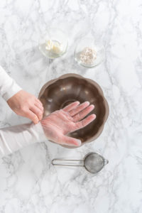 Greasing baking pan - Arina Photography