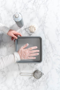 Greasing baking pan - Arina Photography
