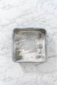 Greasing baking pan - Arina Photography