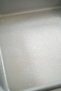 Greasing baking pan - Arina Photography