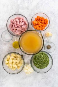 Split Pea Soup - Arina Photography Flat lay. Measured ingredients in glass mixing bowls to make split pea soup.