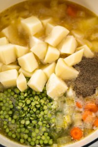 Split Pea Soup - Arina Photography Cooking split pea soup in enameled cast iron dutch oven.