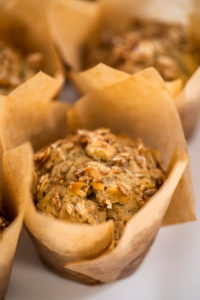 Freshly baked banana oatmeal muffins with oatmeal sugar topping.