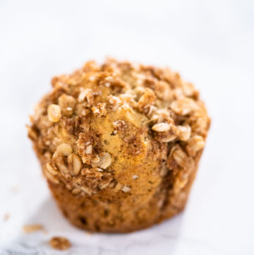 Freshly baked banana oatmeal muffins with oatmeal sugar topping.