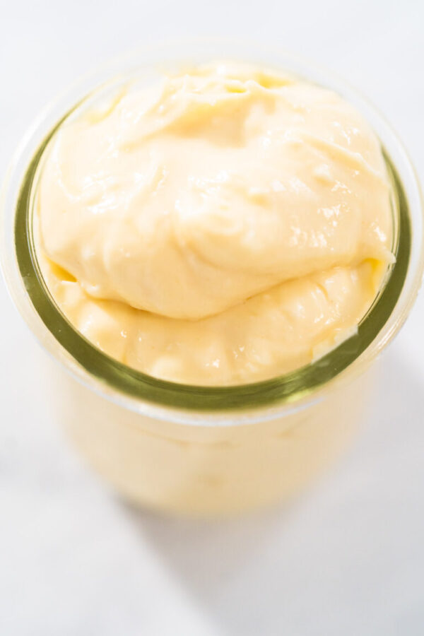 Cream cheese filling for bundt cake in small glass jat.