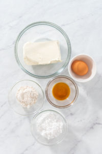 Flat lay. Measured ingredients in glass mixing bowls to make the cream cheese filling.