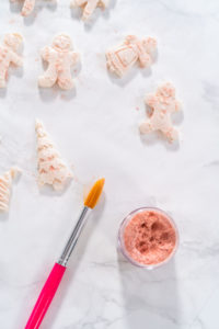 Eggnog Cookies - Arina Photography Dusting chocolate gingerbread man with edible glitter.