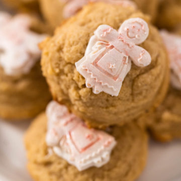 Eggnog Cookies - Arina Photography Pile of eggnog cookies with a chocolate gingerbread man in a stack.