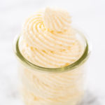 White chocolate ganache frosting in a small glass mason jar.