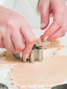 Baking Easter cookies - Arina Photography Step by step. Cutting sugar cookie dough with Easter shaped cookie cutters.