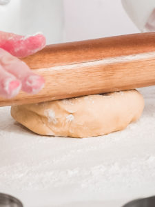 Baking Easter cookies - Arina Photography Step by step. Rolling out Sugar cookie dough with French rolling pin.
