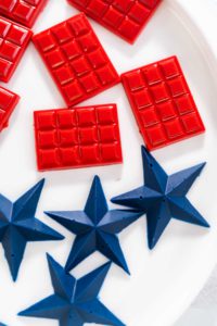 Lemon cupcakes - Arina Photography Close-up of red mini chocolate bars and blue star toppers made with silicone molds.