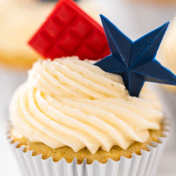 Lemon cupcakes - Arina Photography Frosted cupcake with red chocolate square and blue chocolate star topper.