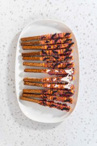 Halloween chocolate-covered pretzel rods - Arina Photography